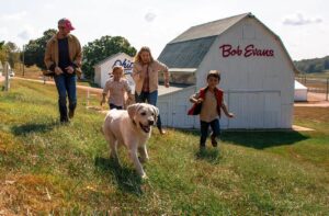 Family and dog running in Bob Evans Farm open thanksgiving