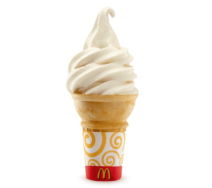 A mcdonald's ice cream cone with whipped cream.