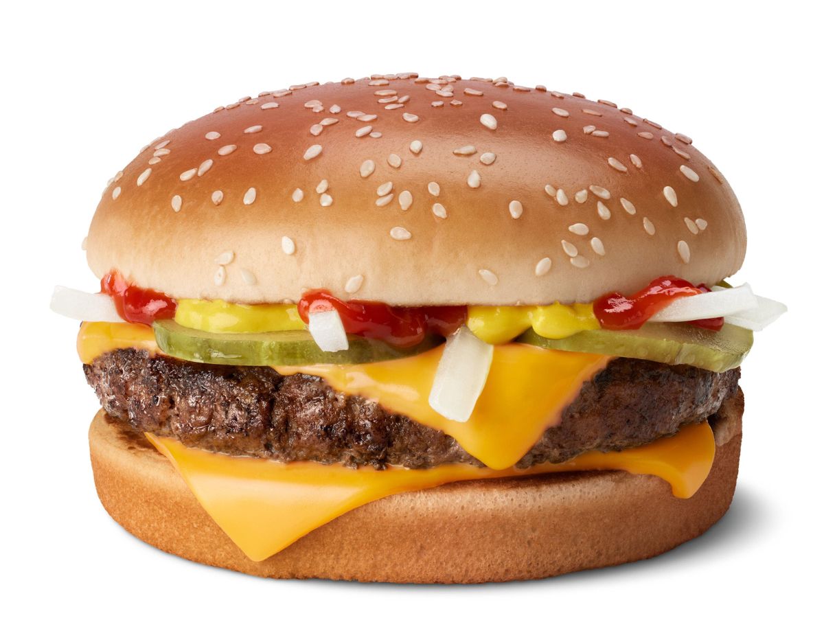 A hamburger with cheese and pickles on a white background.