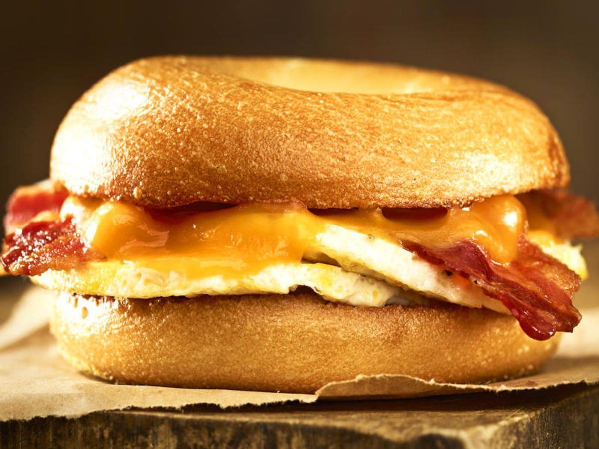 A delicious and convenient bagel sandwich with bacon, eggs, and cheese.