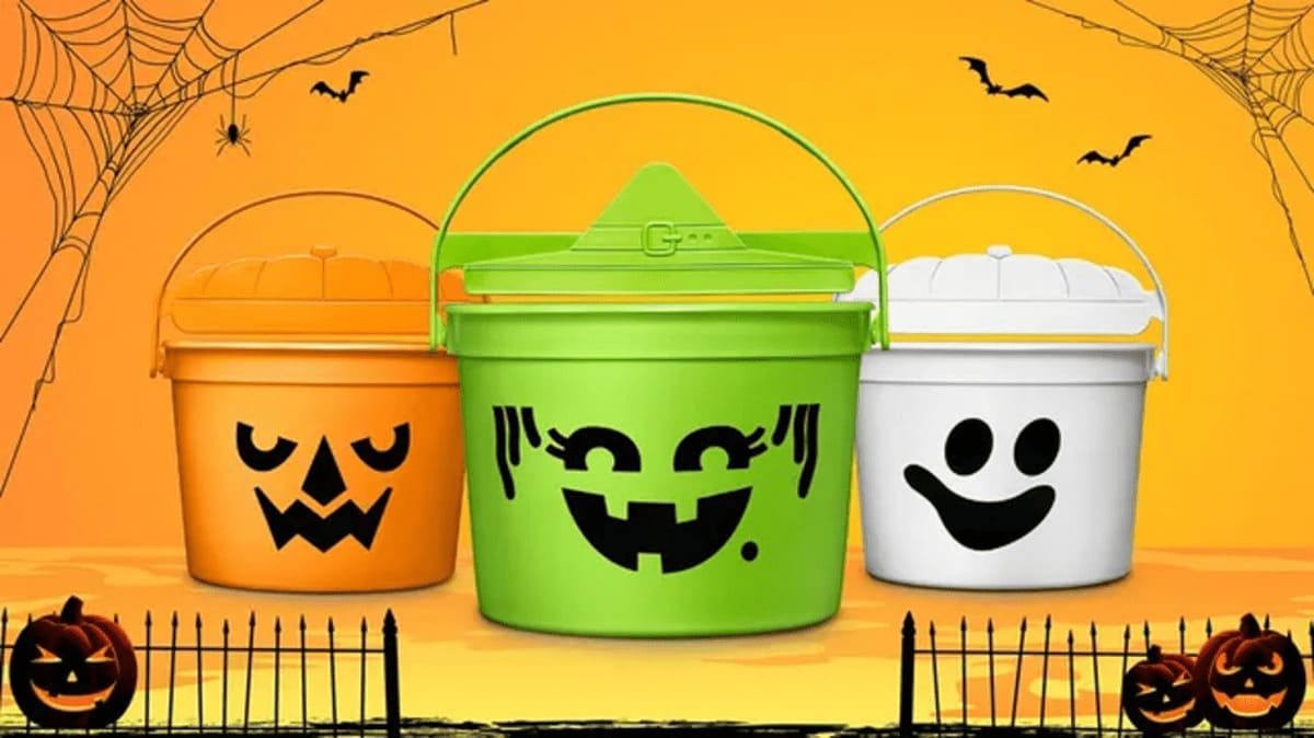 Three halloween buckets with faces on them.