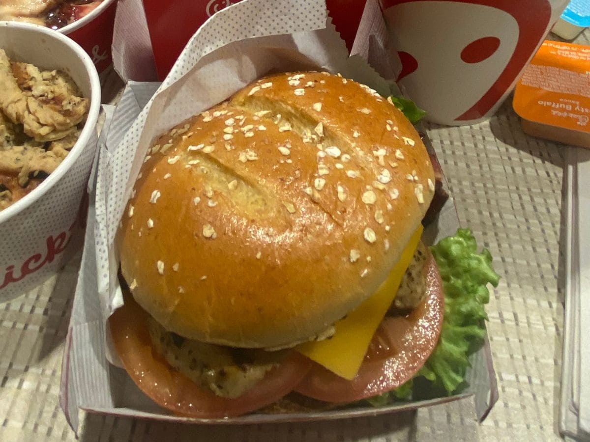 Cheap and fast food presented with a McDonald's burger in a box next to a bowl of food.