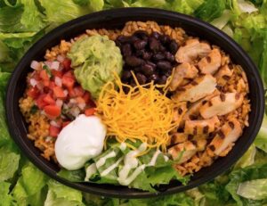 Mexican food bowl with lettuce and guacamole at affordable Taco Bell prices.